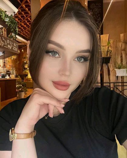 A girl live on a cam to cam chat, her camera on and smiling